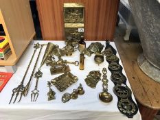 A large quantity of brassware including inkwell, horse brasses, roasting forks etc.
