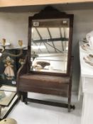 An Edwardian mahogany bathroom mirror