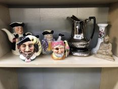 A quantity of character jugs, some teapots and a Buddah figure.
