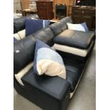 A blue & white sofa with cushions & footstool