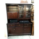 A dark wood stained sideboard wall unit