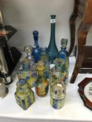 A quantity of coloured decanters etc.