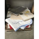 A box of linen etc. Including table cloths & pillow cases etc.