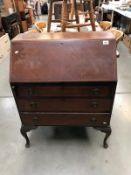 A 1930's mahogany bureau with string inlay on Queen Anne legs