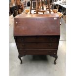 A 1930's mahogany bureau with string inlay on Queen Anne legs