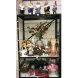 3 shelves of garden gnomes and Christmas decorations