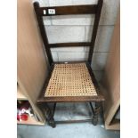 A small darkwood kitchen chair with Bergere seat.