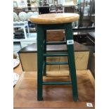 A kitchen stool with green painted base