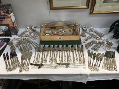 A collection of cutlery and silver plate, cake slices.