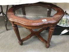 A glass & wooden topped coffee table