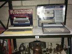 A V Tech pre computer and an electric typewriter