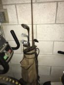 A vintage golf bag and contents