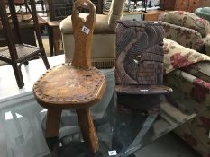 A small carved birthing chair and a spinning chair with leather decorated seat