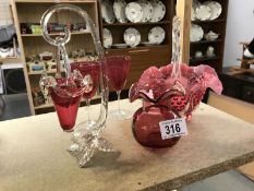 A quantity of cranberry glass items