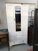 A white painted wardrobe with mirrored door