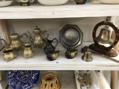 A shelf of brass and pewter including. bell/gong etc.