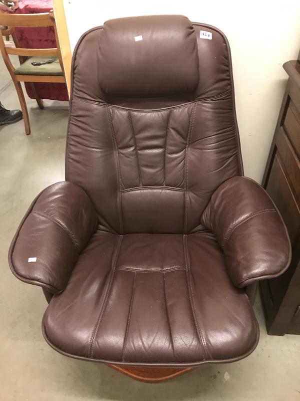 A brown leather swivel chair