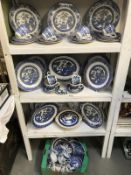 4 shelves of blue and white willow pattern dinner ware etc.
