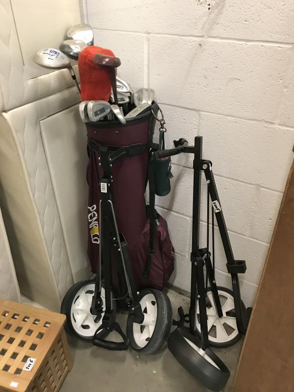 A Penfold golf trolley and golf clubs and 1 other trolley