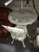 A cast iron garden table and chair