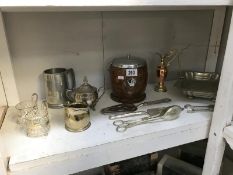 A shelf of silver plate and a biscuit barrel