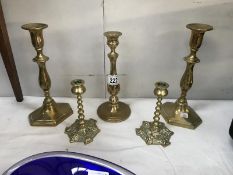 2 pairs of brass candlesticks and a single brass candlestick