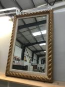 A framed gold painted mirror