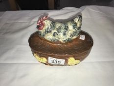 A small vintage lidded dish with a chicken atop
