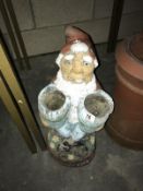 A large garden gnome planter