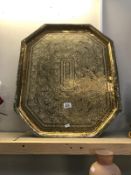 A large brass decorative tray