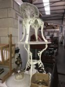 A cast iron garden table and chair