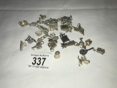 A charm bracelet and quantity of loose charms