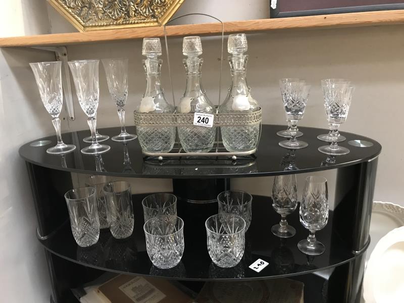 2 shelves of crystal glasses and 3 decanters