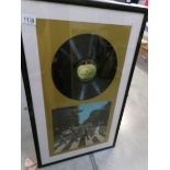 An Abbey Road disc in frame.