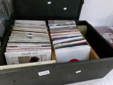 A box of 45 rpm records including Righteous Brothers, Simply Red etc.