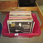 A box of LP records including Genesis, Dire Straits etc.