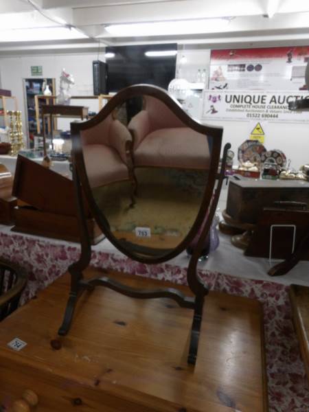 A mahogany shield shaped toilet mirror.