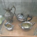 A 3 piece silver plate tea set and a decorative water jug.