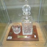 A lead crystal decanter and whisky tumbler on stand.