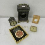 A Victorian clock case, a small clock movement, 2 other clocks and a magnifier.