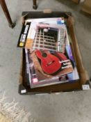 A box containing approximately 25 guitar music magazines all with relevant CD's.