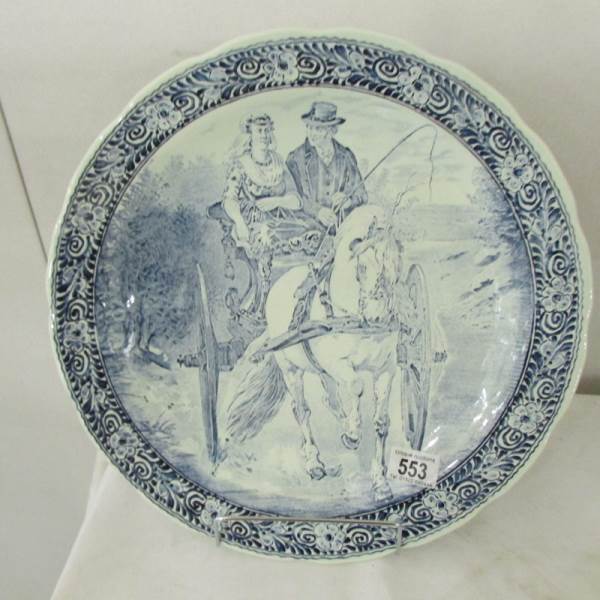 A Delft blue and white charger depicting a horse and cart.