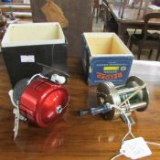 A boxed Record fishing reel and one other.