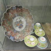 A Chinese plate and a quantity of rice bowls.