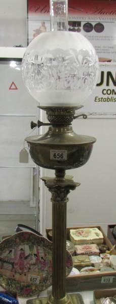 A brass Corinthian oil lamp with etched shade.