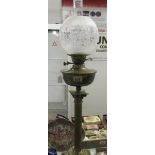 A brass Corinthian oil lamp with etched shade.