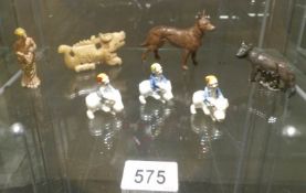 A mixed lot including 2 metal dogs, a metal figure of a lady, ceramic gnomes on pigs etc.