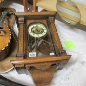 A mahogany inlaid and painted wall clock.