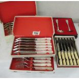 2 boxed sets of fish knives and forks, a boxed set of butter knives and a boxed spoon with pusher.