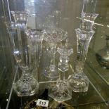 A pair of glass candelabra, a glass candlestick and another glass candle holder.